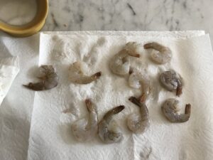patting the shrimp dry with paper towel
