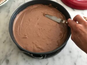 smoothing the top of the cheesecake