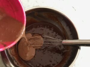adding the egg mixture to the chocolate mixture