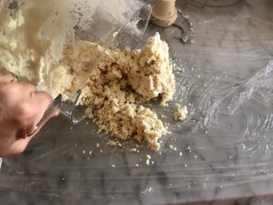 dumping the dough onto plastic wrap