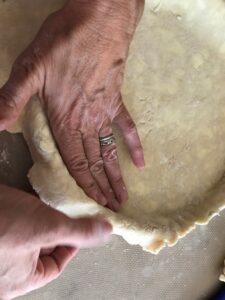 gently pressing the dough into the pan