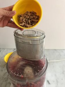 adding walnuts to the food processor