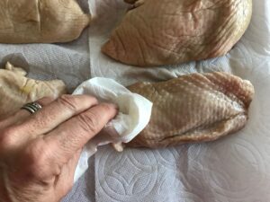 patting the duck breasts dry with a paper towel