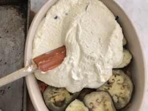putting the cheese mixture on top of the eggplant