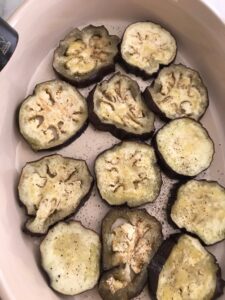 baking dish with eggplant slices in a single layer