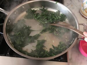 wilted spinach in a saute pan
