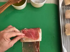 wrapping the fish in procuitto