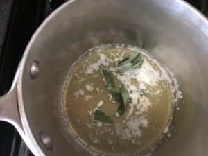 butter and sage in the bottom of a pot