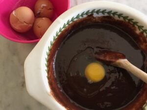 adding the eggs to the chocolate mixture