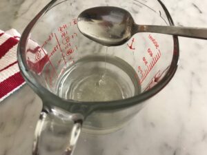 sugar syrup in a measuring cup