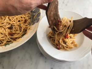 serving the pasta into bowls