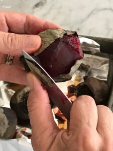 peeling the roasted beets