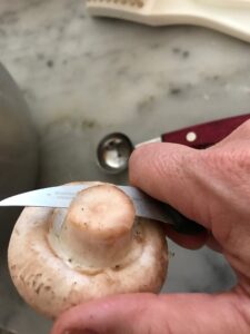 removing the stem of the mushroom