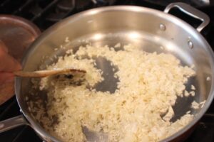 adding the rice to the saute pan