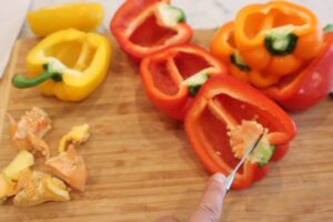 cutting the peppers in half