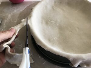 trimming extra pastry off the edges