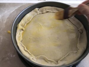 coating the pastry with the egg mixture