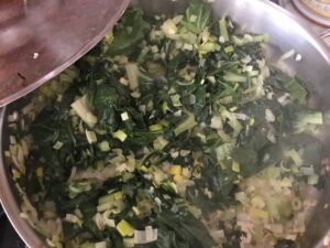 adding spinach and chard to the saute pan