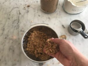 mixing the crumble in a bowl