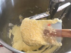 adding eggs to the butter and sugar